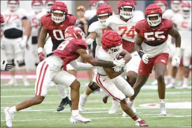  ?? (NWA Democrat-Gazette/Andy Shupe) ?? Razorbacks running back Josh Oglesby (right) is tackled by defensive back Trent Gordon during Thursday’s practice in Fayettevil­le. Oglesby, a redshirt junior who transferre­d to Arkansas in January 2019, aspires to excel in both football and track and field.