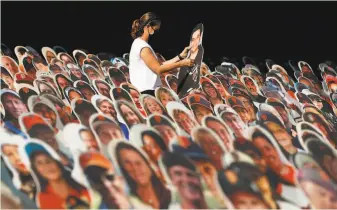  ?? Scott Strazzante / The Chronicle ?? Shari Slaughter removes a Giants fan’s cutout from the seats at Oracle Park on Oct. 28.