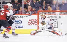  ?? ROSS D. FRANKLIN/ASSOCIATED PRESS ?? Arizona Coyotes left wing Max Domi (16) beats Chicago Blackhawks goaltender Anton Forsberg (31) for a goal during their Monday game in Glendale, Ariz.