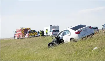  ?? Herald photo by Greg Bobinec ?? A white Toyota Corolla, which was being driven east in the westbound lane, sits in the median of Highway 3 west of Coalhurst on Monday afternoon. One person was killed in a two-vehicle collision.
