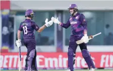  ?? — AFP ?? Scotland’s Chris Greaves (L) and Mark Watt cheer during the ICC T20 World Cup match against Bangladesh.