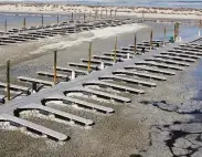  ?? Rick Bowmer / Associated Press ?? Mud surrounds the boat dock at Antelope Island, the largest island within the Great Salt Lake.