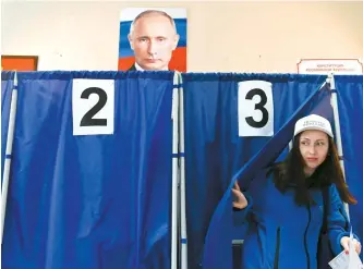  ?? AFP-Yonhap ?? A woman votes in Russia’s presidenti­al election at a polling station in Donetsk, Russian-controlled Ukraine, Saturday, amid the Russia-Ukraine conflict.