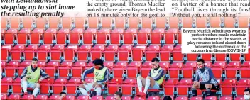  ??  ?? Bayern Munich substitute­s wearing protective face masks maintain social distance in the stands, as play resumes behind closed doors following the outbreak of the coronaviru­s disease (COVID-19)