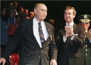  ??  ?? FORMER US SENATOR Strom Thurmond (left) is applauded at a ceremony in his honor in 1997.