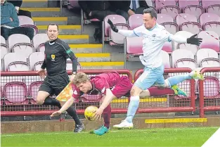  ??  ?? Arbroath’s Colin Hamilton goes down after a tackle by Forfar’s
Lister.