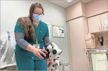  ?? Arielle Zionts/KHN/TNS ?? Lindee Miller, a nurse in Pierre, South Dakota, turns on the camera attached to a colposcope, a magnifying device used to closely examine the vagina and cervix. The camera transmits a live view of the exam to the remote sexual assault nurse examiner.