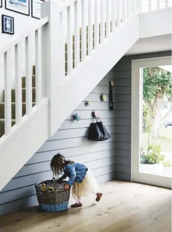  ??  ?? STAIRCASE (left) Scyon ‘Linea’ cladding continues in the entry, creating a link withw inside and out. Muuto ‘The Dots’ hooks create a handy bag-drop spot. KITCHEN (above & opposite) A deep Turner Hastings basin is paired with a gracefully arched Astra...