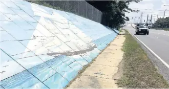  ?? AP ?? In this file photo, traffic passes a mural of the slave ship Clotilda along Africatown Boulevard, in Mobile, Atlanta.