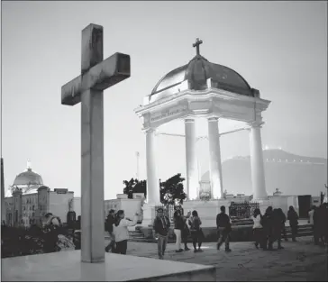  ?? Photos: Rodrigo Abdo/the Associated Press ?? Visitors take a nighttime guided tour through the Presbitero Matias Maestro cemetery in Lima, Peru.