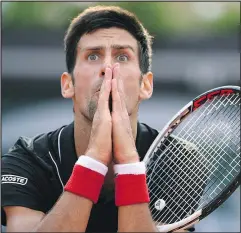  ?? — GETTY IMAGES ?? Novak Djokovic has the look of shock on his way to being ousted by 72nd-ranked Marco Cecchinato yesterday at the French Open in Paris.