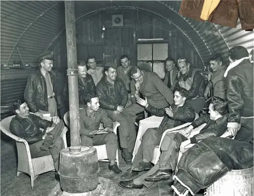  ??  ?? Below: WW II in Europe saw the A-2 jacket become the preferred outer ground garment. Here, aviators gather inside a Quonset hut after a mission. One still wears his B-3 shearling-lined jacket, and a B-2 is draped over a garbage can. (Photo courtesy of the National Air and Space Museum via the author)