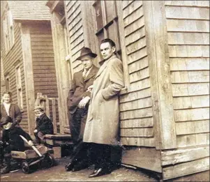  ??  ?? Harold and Nick MacIntosh are seen here in front of Joe Owen’s store. Notice the children playing nearby