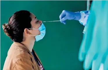  ?? EFE ?? Una mujer se realiza la prueba diagnóstic­a para coronaviru­s en un centro de salud.