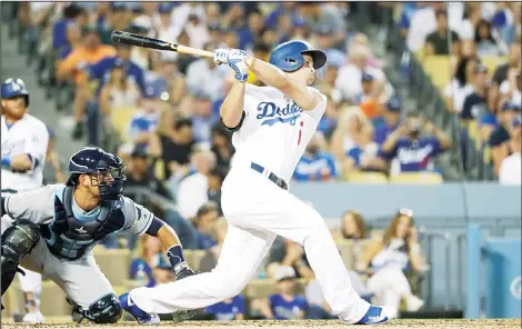 ??  ?? Los Angeles Dodgers’ Corey Seager follows through on an RBI single during the third inning of a baseball game against the Tampa Bay Rays on July 26, in Los Angeles. (AP)
