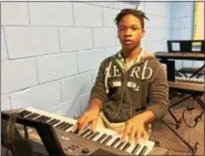  ?? CAROL HARPER — THE MORNING JOURNAL ?? Thirteen-year-old Marcel Emanuel practices after school and thrives in keyboard instructio­n during a Great Expectatio­ns Music program taught by graduates from Oberlin Conservato­ry of Music in Oberlin. The program at New Creation Baptist Church in...