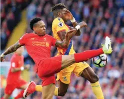  ?? —AP ?? ANFIELD: Liverpool's Nathaniel Clyne , left, and Crystal Palace's Wilfried Zaha battle for the ball during the English Premier League soccer match at Anfield, Liverpool, yesterday.