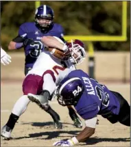  ?? Arkansas Democrat-Gazette/MELISSA SUE GERRITS ?? Minnesota-Duluth’s Beau Bofferding can’t avoid a tackle by Ouachita Baptist’s Etauj Allen in the Bulldogs’ 48-45 overtime victory in the NCAA Division II playoffs Saturday in Arkadelphi­a.