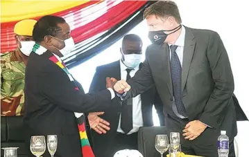  ??  ?? President Mnangagwa greets Kuvimba Mining House chief executive officer Mr David Brown after the official re-opening of Shamva Gold Mine in mid-December