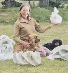  ??  ?? Helen Wrigley with her abstract sculptures and her dogs Chip and Woody. 182550d