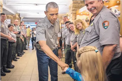  ?? ROBERTO E. ROSALES/JOURNAL ?? President Barack Obama fist-bumps 10-year-old May London, daughter of Eddy County Sheriff Scott London, in the Carlsbad Caverns gift shop before leaving.