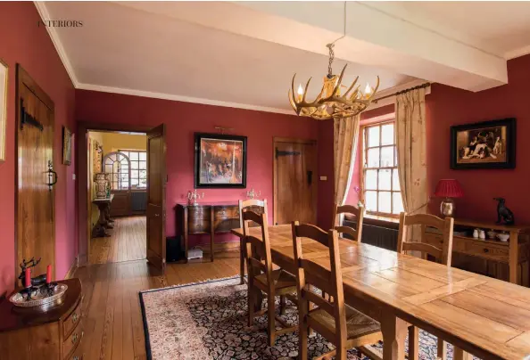  ??  ?? Above: Mahogany antiques and contempora­ry French oak furniture in the dining room. Bottom right: Wooden paneling provides country styling.