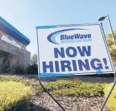  ?? JUSTIN SULLIVAN/GETTY ?? Job cuts from the pandemic recession have fallen heavily on lower-income workers. Above, a hiring sign Feb. 5 at a car wash in San Rafael, California.