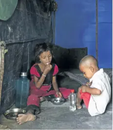  ?? ALTAF QADRI/AP PHOTO ?? Rohingya refugee children eat inside their shanty at a camp for the refugees in New Delhi, India, on Wednesday. A day after the UN chief voiced concern about Indian plans to potentiall­y deport tens of thousands of Muslim Rohingya refugees, an Indian...