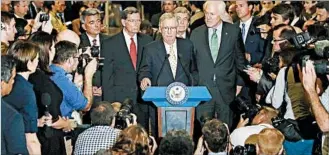  ?? CAROLYN KASTER/ASSOCIATED PRESS ?? Senate Majority Leader Mitch McConnell, at podium, with GOP leaders, speaks Tuesday to the media. A backup plan to repeal Obamacare and delay implementa­tion for two years was dead on arrival.