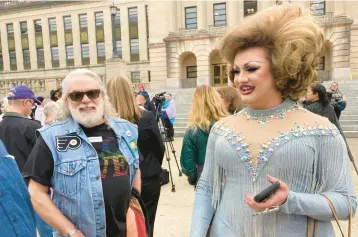  ?? BRUCE SCHREINER/AP ?? Drag performer Poly Tics, right, attends a rally Thursday in Frankfort, Kentucky, to oppose a bill that would put limits on drag shows after speaking earlier during a legislativ­e committee hearing at the state Capitol.