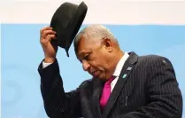  ?? Picture: REUTERS ?? RESPECT: Frank Bainimaram­a, Prime Minister of Fiji and president of COP23, takes off his hat at the start of the final session on Saturday of the UN Climate Change Conference 2017 hosted by Fiji but held in Bonn, Germany.