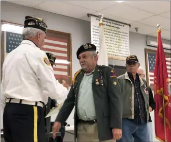  ?? ?? Lionel Goncalves receives a 50-year commemorat­ive pin Saturday to honor Vietnam War era veterans.