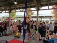  ?? MORNING JOURNAL FILE ?? Maggie Topalian of Chardon performs aerial fabric acrobatics Sept. 17, 2016, at FireFish Festival at Black River Landing with the Jasmine Dragons. Other tumblers performed at the same time.