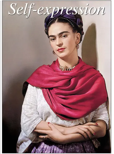  ?? Courtesy Throckmort­on Fine Art, New York ?? Frida Kahlo wears a rebozo (shawl) in Nickolas Muray’s 1939 color carbon print Frida with Magenta Rebozo“Classic.” It is part of an exhibition of photograph­s of Kahlo at the Arkansas Arts Center.