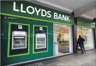  ??  ?? A man enters a Lloyds Bank branch in central London. Lloyds plans to operate three subsidiari­es in continenta­l Europe after Britain leaves the EU, according to a source familiar with the matter, in a sign of how Brexit is fragmentin­g a banking industry...