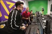  ?? LOS ANGELES TIMES ?? “Mooty” Mitchell Franklin, 25 (left), and “Detoxys” Christophe­r Doyle, 23, react during a scrimmage against the Minnesota Timberwolv­es 2K team in the gaming room at the Lakers practice facility.