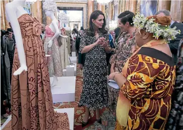  ?? PHOTO: GETTY IMAGES ?? Catherine, Duchess of Cambridge, Karen Walker and Tukua Turia beside the gown the New Zealand pair, plus a group of Cook Islands craftswome­n, created for the Commonweal­th Fashion Exchange Reception at Buckingham Palace in London.