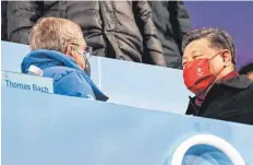  ?? FOTOS: LAN HONGGUANG/IMAGO IMAGES, MICHAEL KAPPELER/DPA, ANTHONY WALLACE/AFP ?? Farbenfroh endeten die Spiele in Peking (Bild oben). Thorsten Margis trug die deutsche Fahne ins Stadion (Bild unten links), Thomas Bach (li.) und Chinas Präsident Xi Jinping verstanden sich am Rande der Zeremonie offenbar prächtig (Bild unten rechts).