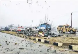  ?? REUTERS ?? Soldiers examine the debris after a terrorist attacked a CRPF convoy in Pulwama on Thursday.