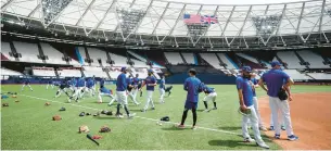  ?? ZAC GOODWIN/PA VIA AP ?? Chicago Cubs players work out ahead of the MLB London Series at London Stadium.