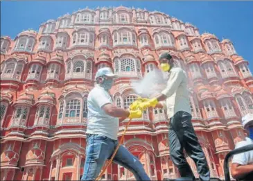  ??  ?? Health workers sanitise an area by spraying disinfecta­nt around the Hawa Mahal in Jaipur on Monday, the foundation day of Rajasthan, after curfew was imposed in the walled city following Covid-19 cases. HIMANSHU VYAS/HT PHOTO
