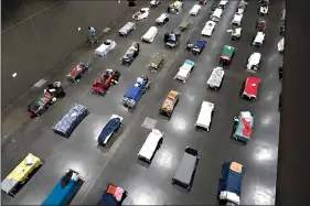  ?? (AP Photo/Gregory Bull) ?? Beds fill a homeless shelter Aug. 11 inside the San Diego Convention Center in San Diego. When the coronaviru­s emerged in the U.S. earlier this year, public health officials and advocates for the homeless feared the virus would rip through shelters and tent encampment­s, ravaging vulnerable people who often have chronic health issues. Yet, the virus so far does not appear to have brought devastatio­n to the homeless population.
