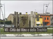  ??  ?? Writing reading in Italian “Vo - Town of wine and trachyte” embraces a sculpture on a roundabout.