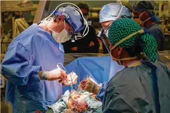  ?? Karen Warren/staff file photo ?? Surgeons with the Houston Methodist Debakey Heart and Vascular Center prepare for a heart transplant. The national transplant system has been criticized for wait times and inequities.