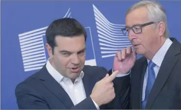  ?? PHOTO: EPA ?? Greece’s Prime Minister Alexis Tsipras (left) is welcomed by European Commission president Jean-Claude Juncker ahead of an emergency summit in Brussels yesterday. While some progress has been made on Greece over the weekend, leaders ‘are not yet there’.
