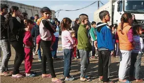  ??  ?? Young Syrian refugees lining up during a gift distributi­on in a slum in the town of Dbayeh, north of Beirut. Last year, funds raised through TripAdviso­r’s charity project were used to provide essential education and empowermen­t opportunit­ies for...