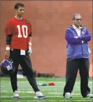  ?? Julio Cortez / Associated Press ?? Giants quarterbac­k Eli Manning, left, stands next to general manager Dave Gettleman on Wednesday in East Rutherford, N.J.