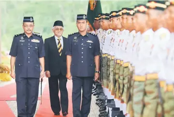  ??  ?? The Head of State (centre) inspects an honour guard at the state-level Warriors’ Day 2017. — Photo by Muhammad Rais Sanusi