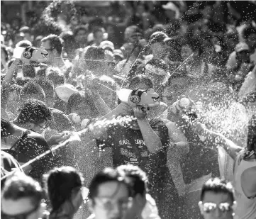  ??  ?? Revellers take part in a water fight at Songkran Festival celebratio­ns in Bangkok, Thailand. — Reuters photo