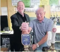  ??  ?? ●●Steve Bellis and Ken Scott pull the first pint